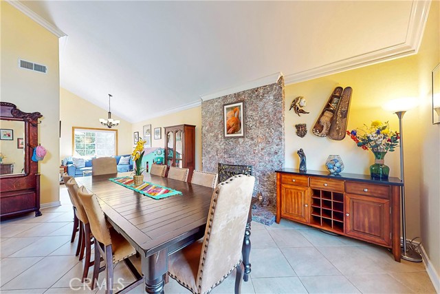 Living room with tiled flooring and fireplace, seller put a large dining table there