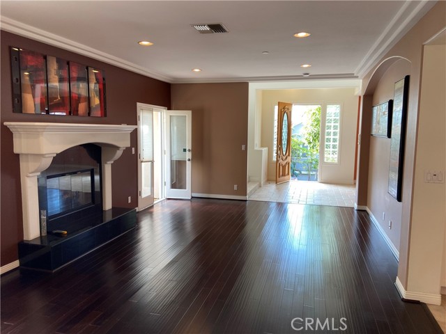 Living room with wood flooring and recessed lighting