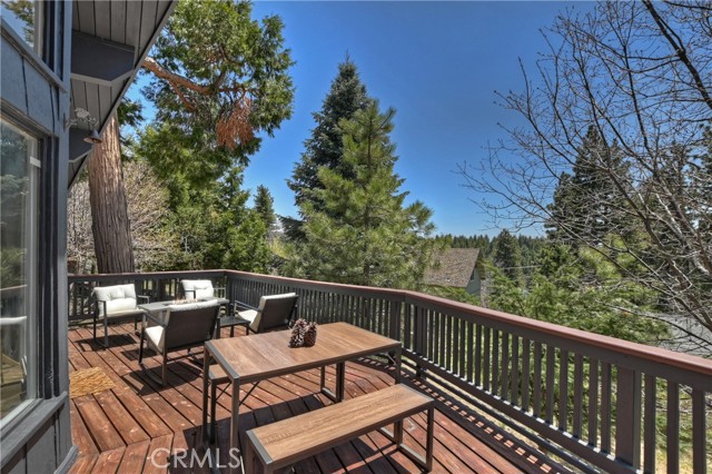Back deck with dining set, chairs, and fire pit included