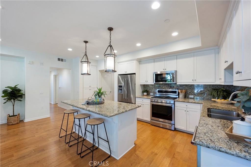 The Kitchen is the center of the home with ample storage, a floor to ceiling Pantry, Stainless Steel Appliances, and tons of space to entertain.