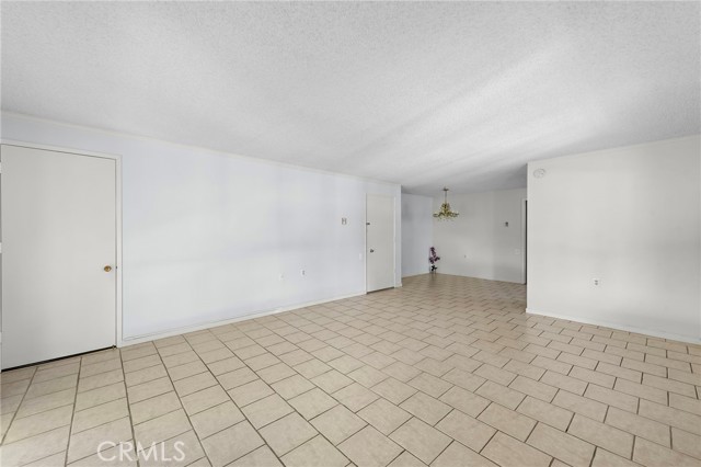 Another view of the open concept of the Dinging room and living room, 
& of the front entrance door at the right and the other door is a convenient t closet door.