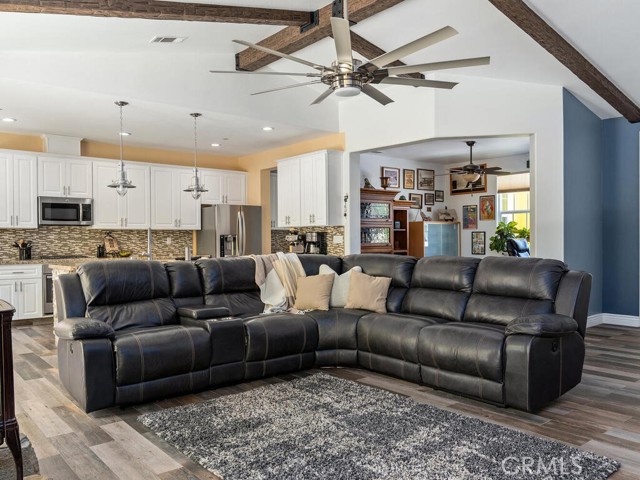 Great room with kitchen and entrance to formal dining at the rear