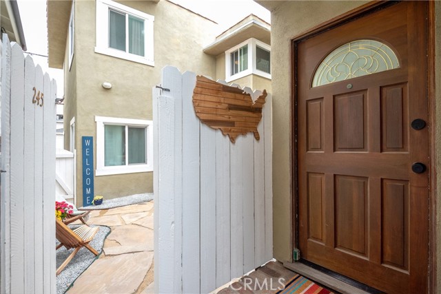 Entry Door To Front House And Sneak Peek Through Gate To Patio & Entrance To Rear Unit