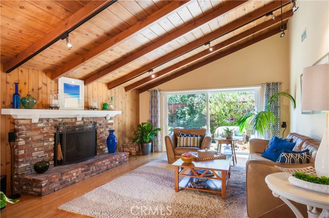 Wood paneling and Vaulted ceilings in Living Room with custom brick fireplace