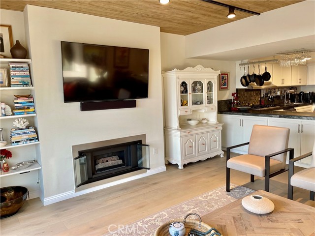 Livingroom with fireplace opens to balcony
