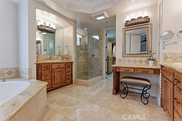 Sophisticated Spa-style master bath with 2 separate vanities plus a makeup vanity, light and bright!