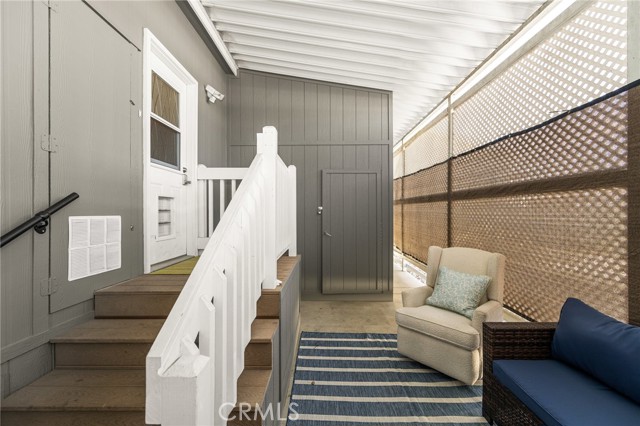 Fenced in sitting area off the laundry room and carport , along with a storage shed.