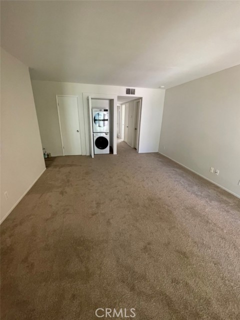 Living room with stackable washer/dryer