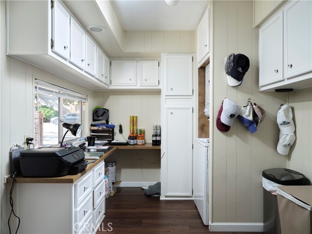 Laundry room with desk and storage.