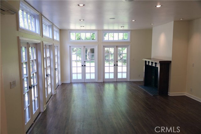 Spacious Play Room With Fireplace that  French Doors that leads to you to backyard