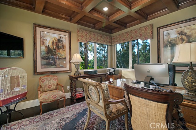 The downstairs light and bright office features an icebox ceiling, grand views and extra-large crown moulding with French doors that open to the driveway.