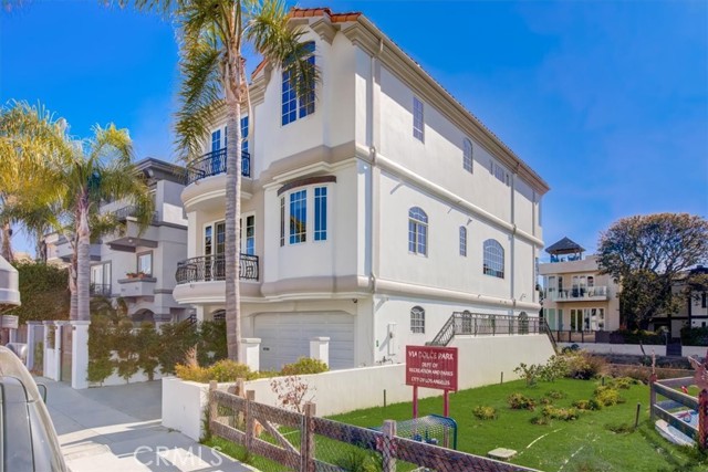 Front shot of the home showcasing it nestled up against Via Dolce park which gives this home a special vantage point and a flood of natural light!