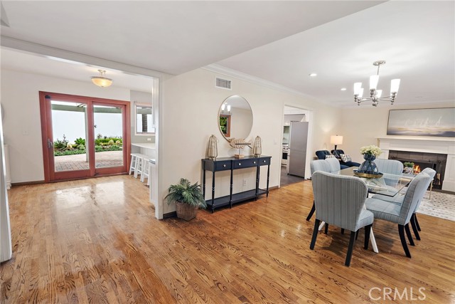 Front room functions as a dining room with a sitting area with a fireplace.