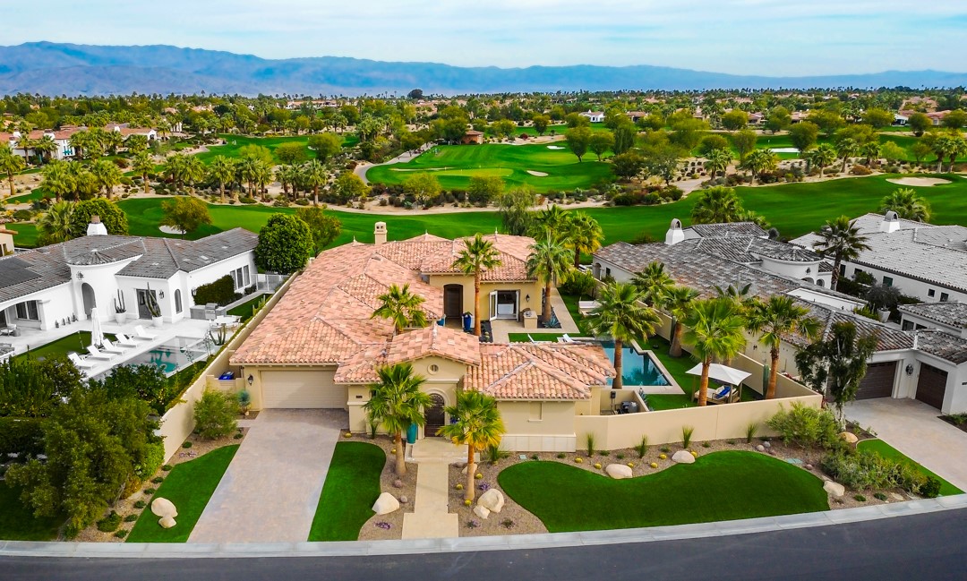 This exquisite single-level home features four bedrooms and four ½ baths, along with a separate casita, providing ample space and privacy. The property offers panoramic views of the 10th fairway, driving range, and the stunning Chocolate Mountains beyond. The interior boasts a stunning great room that enhances your living experience, with all rooms either opening or facing the golf course. The finest quality is maintained throughout the home, with porcelain tile flooring adding to the elegance. The gourmet kitchen is a chef’s dream, featuring a large center island, slab granite countertops, and top-of-the-line appliances. This space is designed for both functionality and style, making it ideal for entertaining and everyday use. The primary suite bedroom offers solace and privacy, with a spacious layout and an opulent ensuite bath. The bathroom includes granite slab countertops, double vanities, a soaking tub, and spacious built-in walk-in closets. With over 3,600 square feet of interior space and a premier location on a lot exceeding 15,000 square feet, this home provides both luxury and comfort.
Residents of this property can enjoy the exclusive Toscana Country Club lifestyle, which includes access to two Jack Nicklaus Signature Golf Courses, driving ranges, and the Bill Harmon Golf Performance Center with top PGA instructors. Additional amenities include pickleball, a pool, spa, and hot tub. The exclusive country club dinner house is open year-round, offering a variety of membership benefits and dining experiences. Members will find easy access to major freeways, fine dining, designer shopping, hospitals, medical and financial facilities, and the historic downtown Palm Springs. This property offers a unique blend of luxury, privacy, and convenience, making it the perfect place to call home.