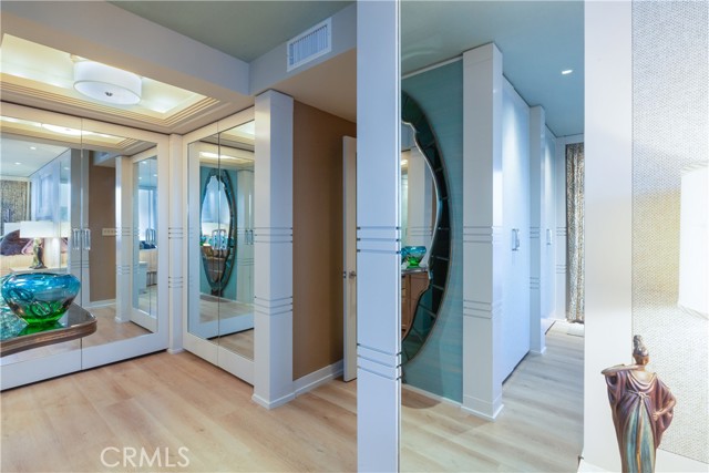 walls lined with closets lead to primary bathroom