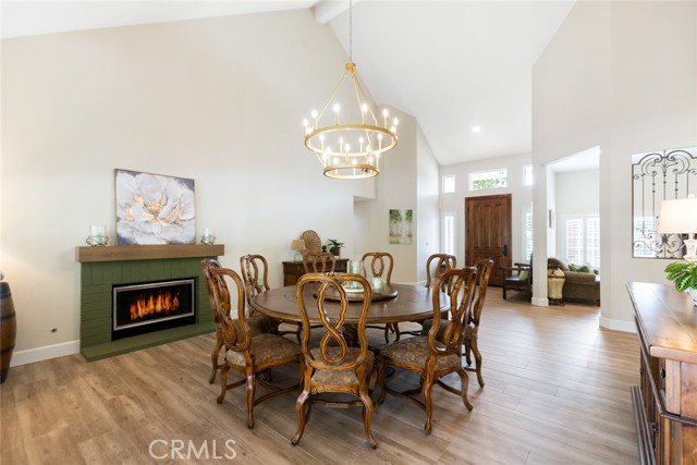 The dining room could also be used as a formal living room. No matter what you use this room for, you will appreciate the vaulted ceilings, tasteful designer style drop down light and a cozy fireplace.