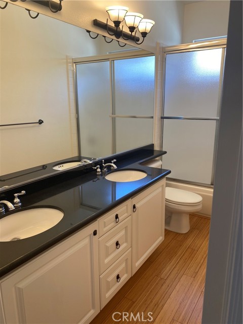 Shared bathroom with dual sinks