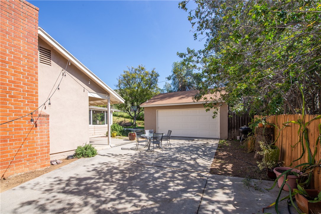 The long driveway leads to the detached two car garage.