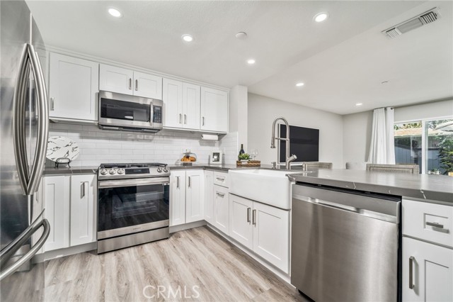 Elegant Upgraded Kitchen with Leather Quartz Countertops