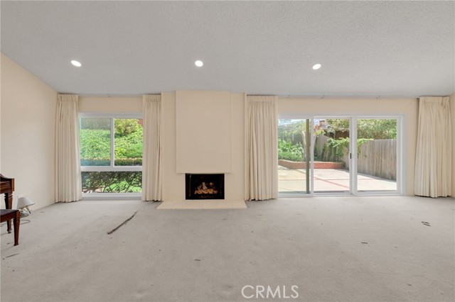 Living Room w/Fireplace & Vaulted Ceilings