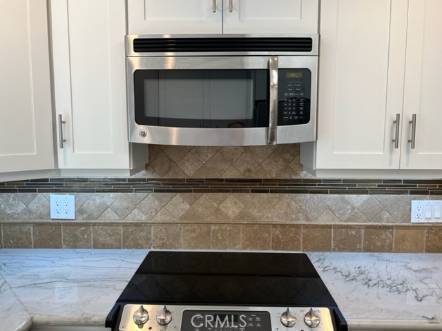 Gleaming stainless steel appliances and granite counters.