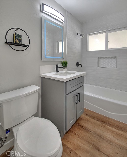 Bathroom w/New Toilet, New Sink, New Fixtures, New Vanity, New Designer Tile Work on Tub.