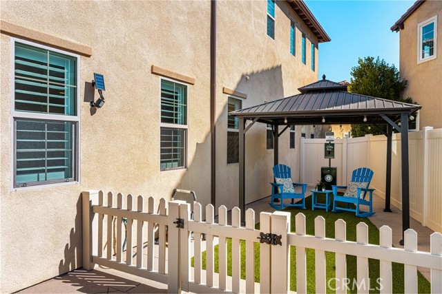 Charming Side Patio with Private Seating and Dog Run Area