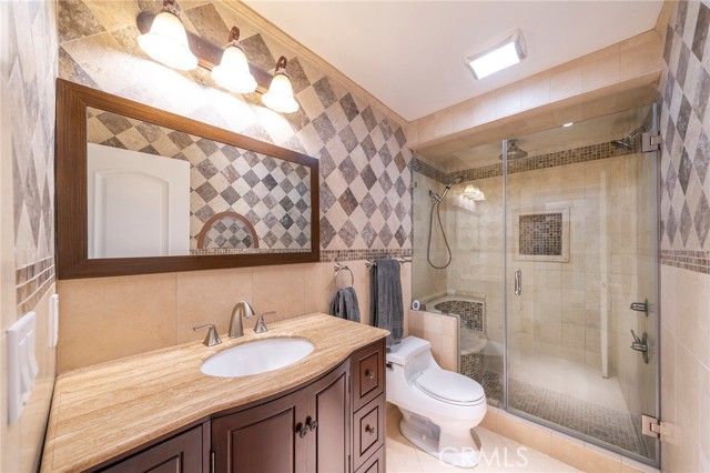 Comfortable bath area with walk in shower and a built in shower chair to safely wash your feet.