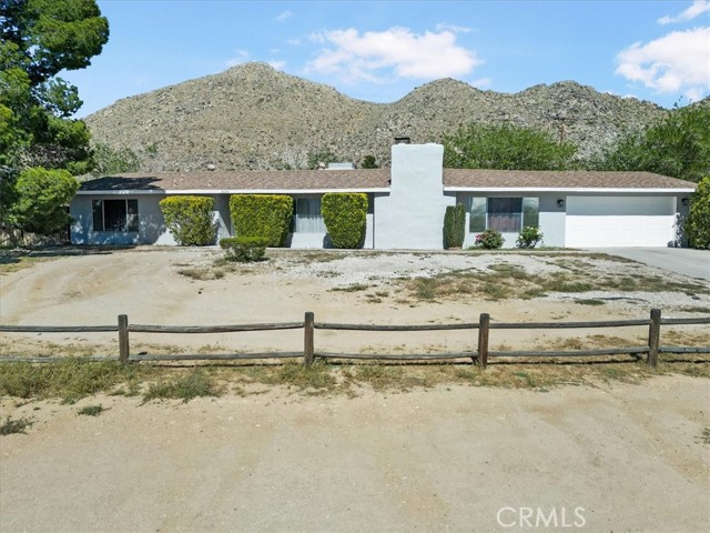 Easy access to Hwy 18 and freeway. Newly renovated kitchen with new cabinets, appliances and stunning quartz counter tops. 3 bedroom 2 bath house with a den that is being used as a 4th bedroom.  Large .69 acre corner fenced lot. Exterior has just been completely painted. Large covered patio. In ground pool will be filled before close of escrow.  Beautiful mountains provide a majestic backdrop for the pool area. Circle driveway in front for convenience.  Rv parking.  Plenty of room for toys and for pool parties and BBQ's in the backyard.