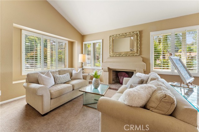 Formal entry with step up to formal dining with through way to kitchen. Opposite side of stairs circles to family room with dry bar and kitchen.