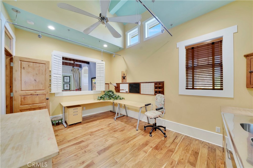 hobby room with high ceilings and ceiling fan