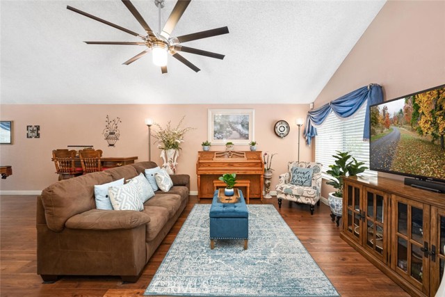 Living room features a warm color palette. vaulted ceilings.