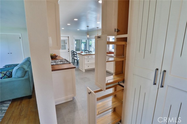 Between kitchen and living room are 3 cupboards of space, with a surprise nearby!