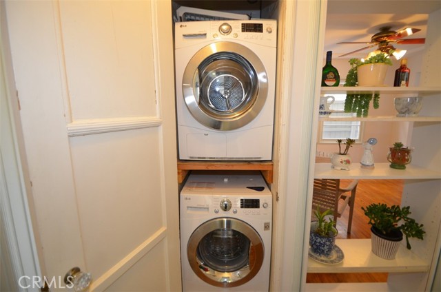 A stackable washer and dryer tucked away in the hallway closet.