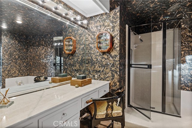 The primary bath is complete with a vanity table.