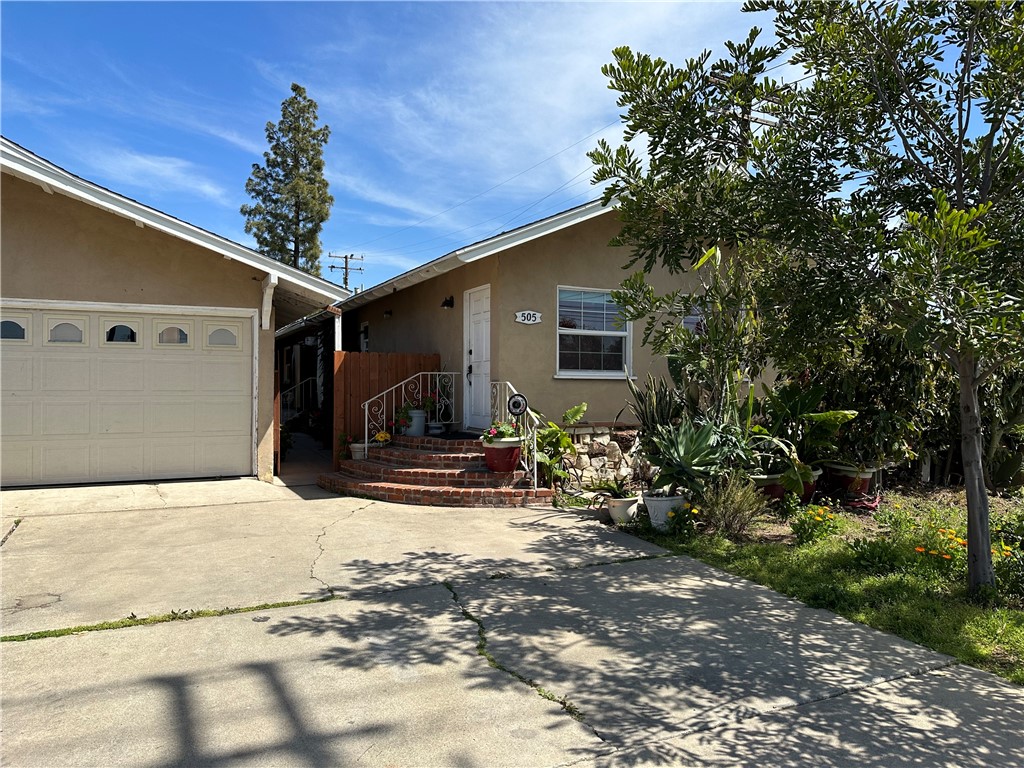 Front facing Hewes Street, two car detached garage with courtyard leading to side entryway