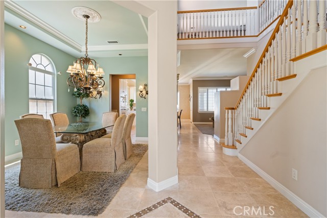 2 story foyer invites you into an open floor-plan concept. Stone flooring and warm tones.