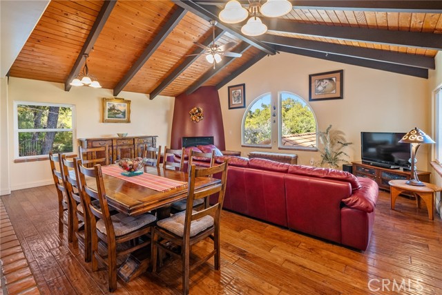 Absolutely stunning living room with soaring wood beam ceilings and engineered hardwood floors.