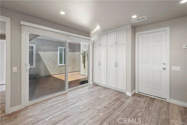 Looking from the sink towards the gated courtyard. Even more cabinets for storage in the kitchen and the door to the 2 car garage.
