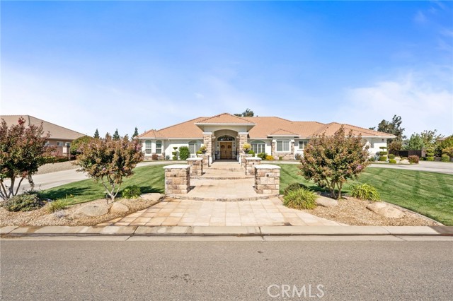 Travertine tile steps lead to the front entry