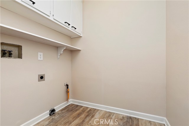 Laundry Room located between garage door access and the kitchen