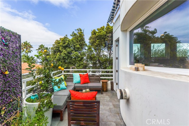 Deck off of living room has two doors & ocean view