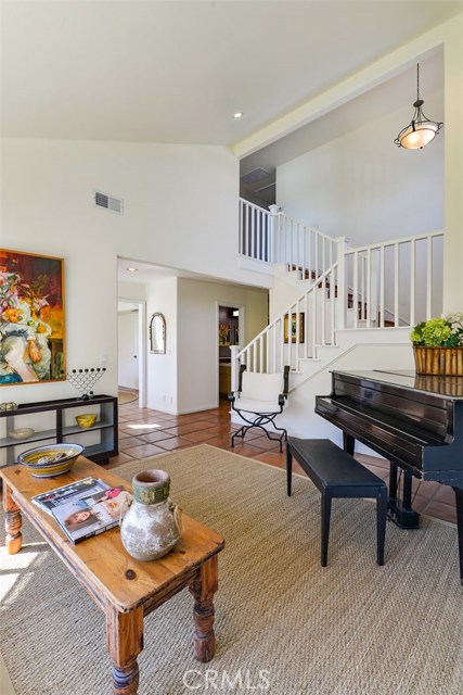 Living room with a shot of the stairs to the bedrooms, office, and 2 full bathrooms.