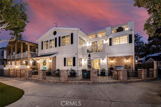 1501 E Balboa Boulevard Newport Beach, California Nestled between the beach & bay on the Balboa Peninsula Point, the perfect beach home awaits. This show stopping stunner sits on an oversized corner lot adjacent to a charming tree-filled park which feels like an extension of your property, offering unique privacy w/only one neighbor on one side. Completely renovated in 2015 with new plumbing, electrical, water filtration + softening systems, appliances, surround-sound, AC, roof & custom precision millwork, you can immediately begin enjoying this turnkey home w/total peace of mind. As you approach the gated front entry you’re greeted by a spacious outdoor entertainment area with a built-in bbq, fire-pit & ample seating. The chic blue dutch-door whisks you inside where you’ll find a cozy seating area with a crackling fireplace and generous secondary kitchen, the ideal setup for front yard gatherings and overnight guests or in-laws. A main level master bedroom w/ensuite bath and private patio, as well as an additional bedroom w/walk-in closet and full bath, create a great multigenerational-family option. The spectacular second level embodies timeless coastal charm with modern sophistication. A cozy great room with vaulted ceilings and fireplace opens naturally to the primary kitchen and dining area for 8+. The Master Suite is adorned with an enormous bath, a steam shower, tub, walk-in closet and quaint balcony. 2 additional bedrooms, full bath & laundry closet complete the second floor. The third level rooftop deck will rock your world. An entertainer’s dream and a delight for all ages, it offers approx 700 sq.ft. of covered fun & relaxation, with a large sectional, 4 TVs w/ surround sound for the big game!, fireplace, gas heaters, bbq, beer tap, refrigerators, ice maker, a shuffleboard, and an uncovered dining area when you feel like basking in the ocean sun. To top it all off the entire deck is weatherproofed w/ automatic metal storm shutters that’ll keep out the rare Newport rainfall. A car aficionado’s dream, a rare 4 car garage provides ample parking+storage, a secondary laundry unit, along w/3 additional driveway spots (never hunt for beach parking again). The Peninsula is the ideal sanctuary to raise a family or retreat for the weekend, famous for the Wedge Beach surfing spectacle & its iconic festivities, including the Christmas Boat Parade, 4th of July fireworks, private Bay Beach & tennis club, all just steps from the sand & ocean. Don't miss your chance to make this slice of paradise your home.