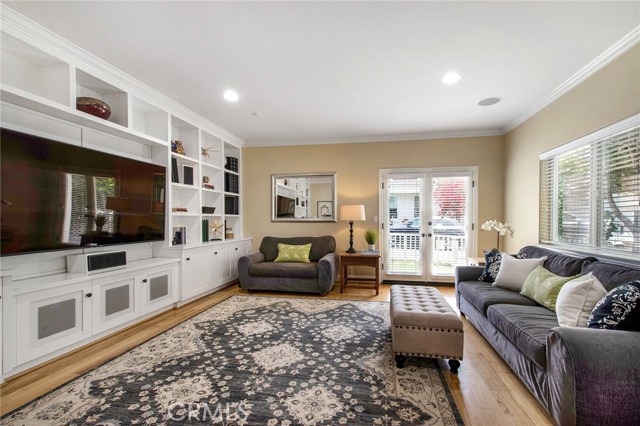 Bonus/media room first floor with French doors going to grassy yard out front.