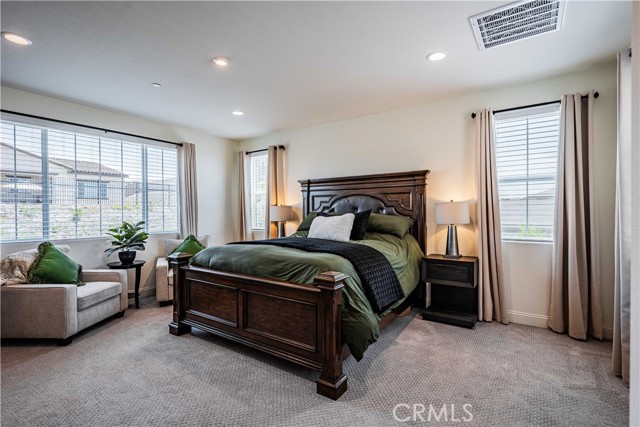 Upstairs Primary bedroom is massive! Tons of windows allow you to see mountains forever all around! Natural light and recessed lighting. Upgraded burbor carpet here. Sellers chose to make a cozy sitting area next to the wiindows tto take in the stellar views!