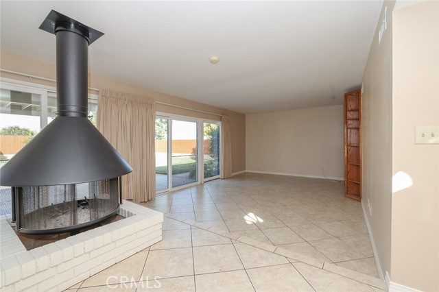 Unique wood burning fireplace between dining/family room and great room