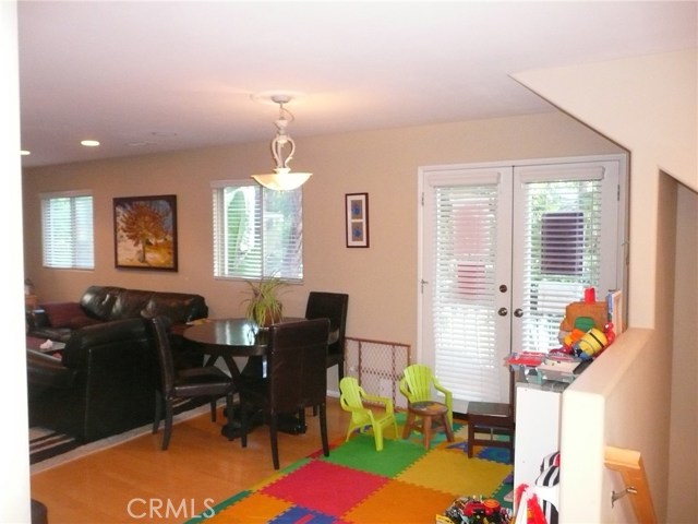 Eating area opening up to the living room (photo was taken with a prior occupant's furniture)