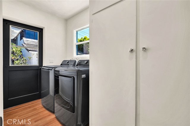 laundry area with access to back yard\n
