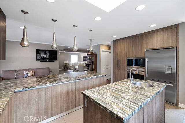 From the back of the custom updated kitchen looking into the open living and entry family seating areas.